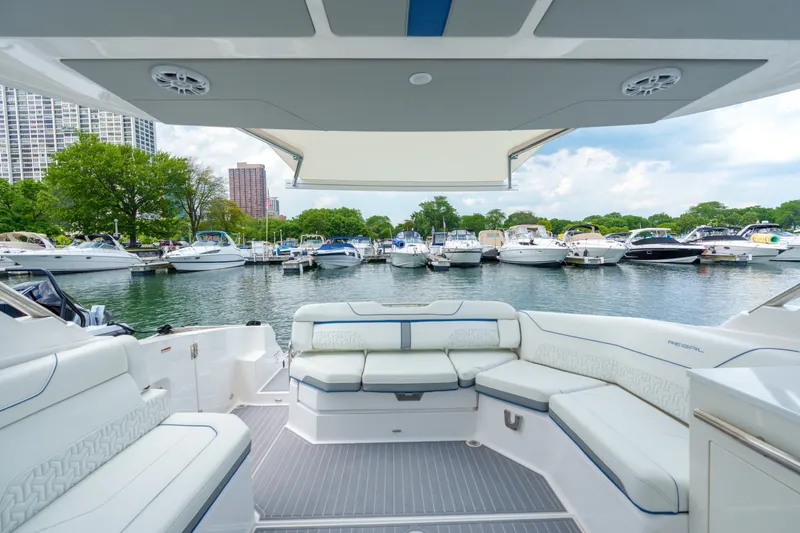 Slide: The Image of 2023 Regal LS36 luxury boat interior with marina view, featuring elegant seating and modern design. - 41