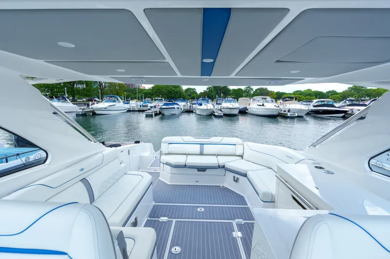 Slide: The Image of Luxurious 2023 Regal LS36 boat interior with marina view and elegant seating. - 25