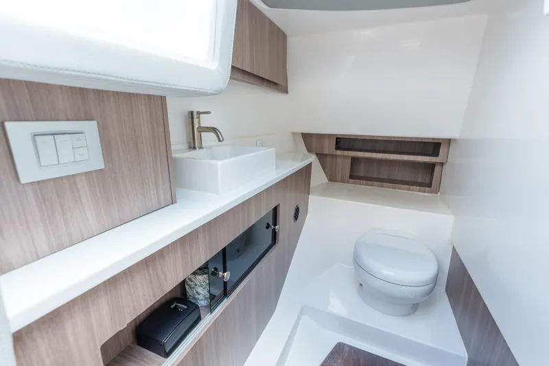Slide: The Image of Luxurious bathroom interior of 2023 Regal LS36 boat with modern fixtures and wood accents. - 34