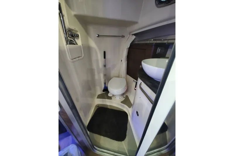 Slide: The Image of Bathroom interior of 2020 Boston Whaler 345 Conquest boat, featuring toilet and sink. - 26