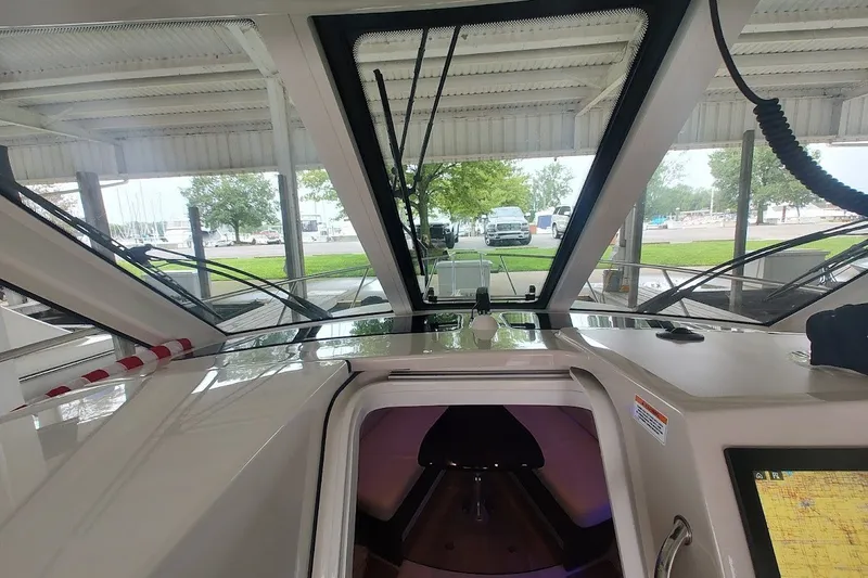 Slide: The Image of Interior view of 2020 Boston Whaler 345 Conquest boat under a covered dock. - 14