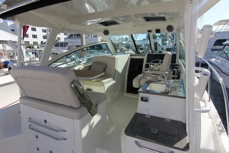 Slide: The Image of Manufacturer Provided Image: 2020 Boston Whaler 345 Conquest interior with helm station and seating area. - 13