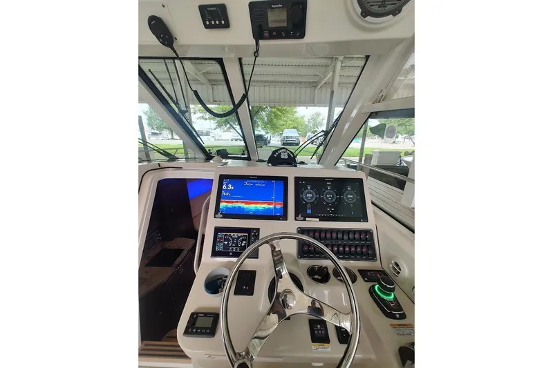 Slide: The Image of Cockpit of 2020 Boston Whaler 345 Conquest with advanced navigation displays and controls. - 15