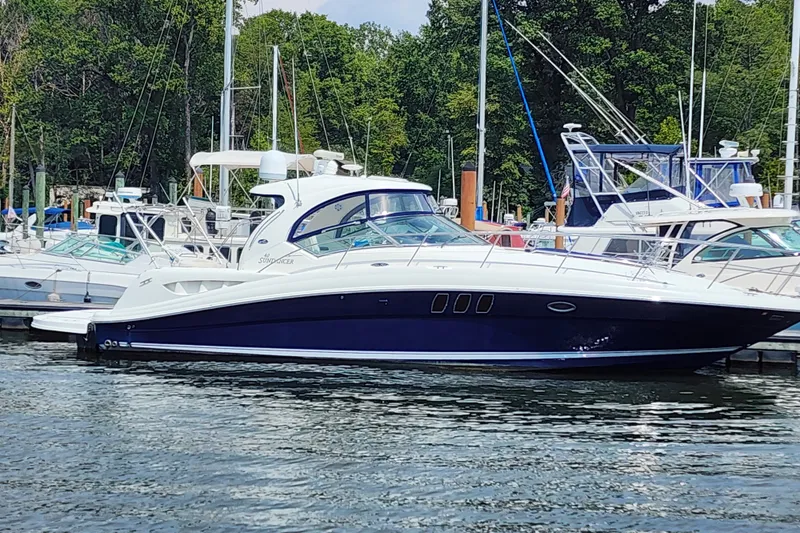 Slide: The Image of 2006 Sea Ray 40 Sundancer yacht docked at marina, surrounded by other boats. - 58