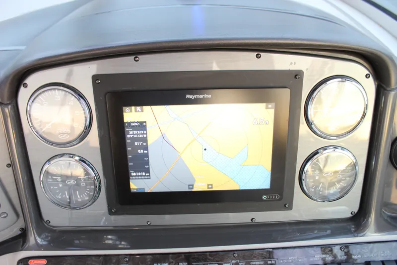Slide: The Image of Dashboard of a 2006 Sea Ray 40 Sundancer with navigation display and gauges. - 55