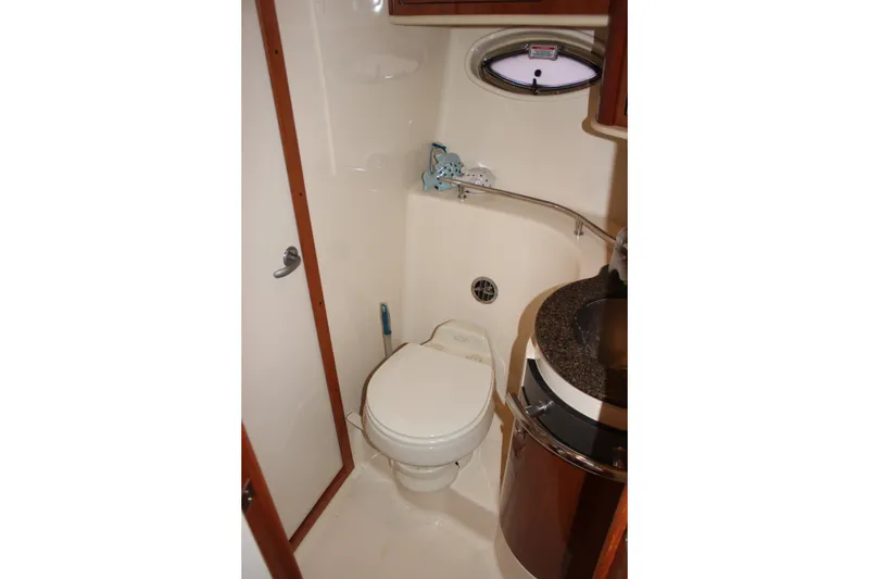 Slide: The Image of Bathroom interior of 2006 Sea Ray 40 Sundancer yacht, featuring toilet and sink. - 40