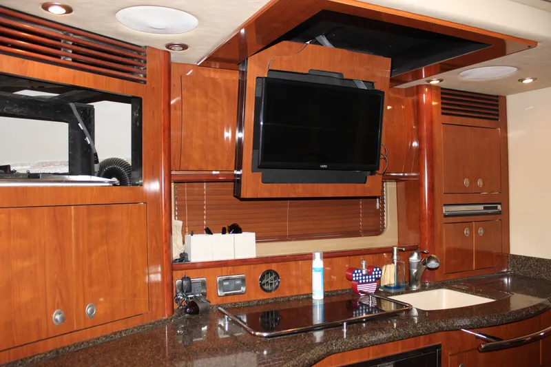 Slide: The Image of Luxurious 2006 Sea Ray 40 Sundancer yacht interior with wood cabinetry and modern amenities. - 48