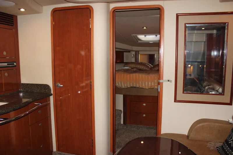 Slide: The Image of Interior of 2006 Sea Ray 40 Sundancer yacht, featuring wood cabinetry and cozy sleeping quarters. - 26