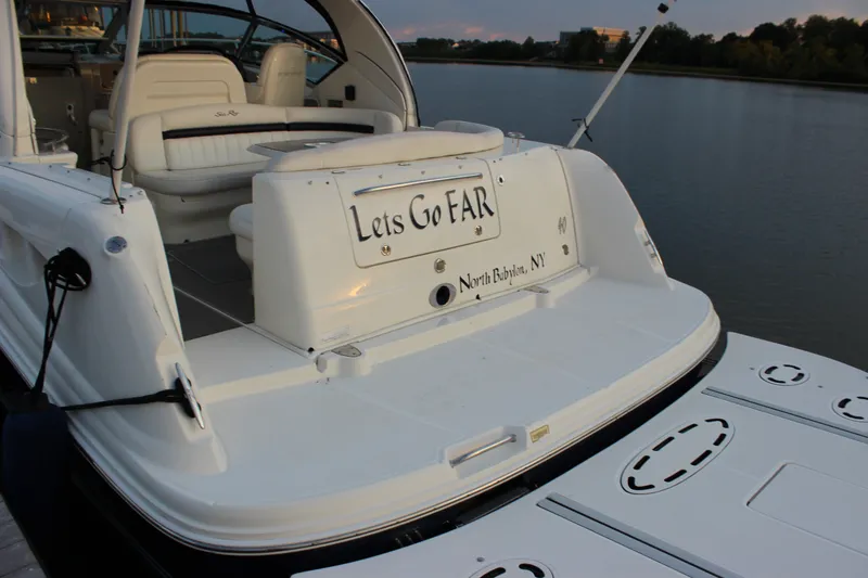 Slide: The Image of 2006 Sea Ray 40 Sundancer yacht docked, featuring spacious seating and "Lets Go FAR" signage. - 2