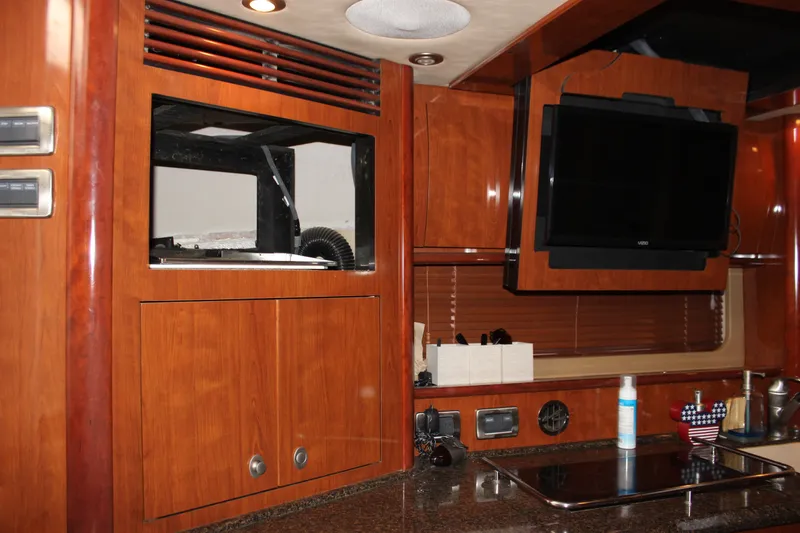 Slide: The Image of Interior of 2006 Sea Ray 40 Sundancer yacht with wood cabinetry and mounted TV. - 49