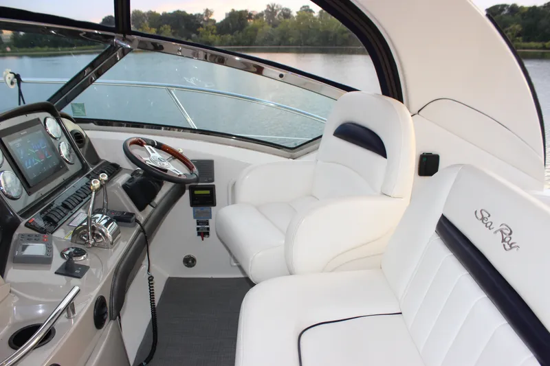 Slide: The Image of Helm of 2006 Sea Ray 40 Sundancer with luxurious white seating and modern controls. - 18