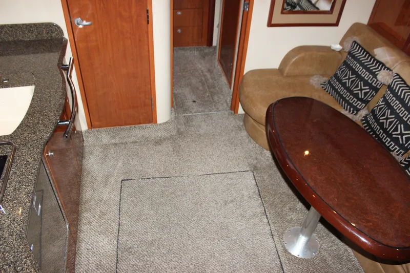Slide: The Image of Interior of 2006 Sea Ray 40 Sundancer with plush seating and elegant wooden table. - 24