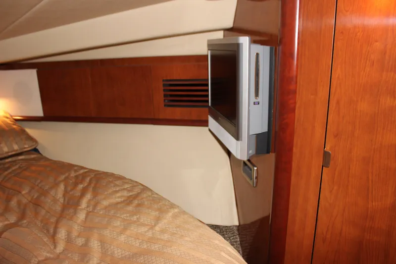 Slide: The Image of Luxurious cabin interior of 2006 Sea Ray 40 Sundancer yacht with TV and wood paneling. - 33