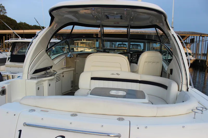 Slide: The Image of 2006 Sea Ray 40 Sundancer yacht interior with white seating and helm station. - 5
