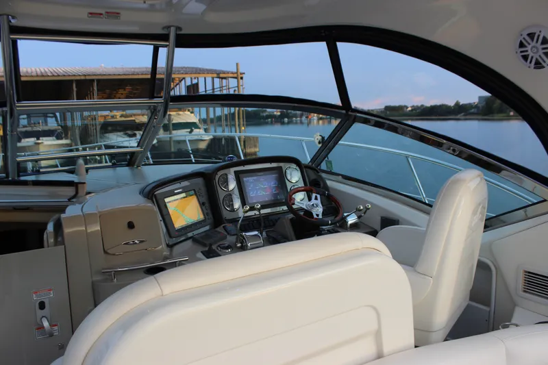 Slide: The Image of Helm of 2006 Sea Ray 40 Sundancer yacht with navigation equipment and waterfront view. - 13