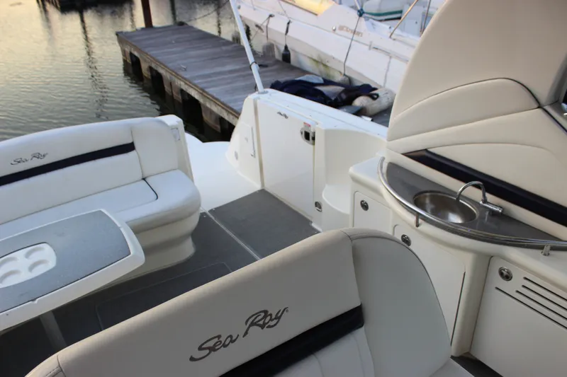 Slide: The Image of 2006 Sea Ray 40 Sundancer yacht interior with seating and kitchenette by the dock. - 22