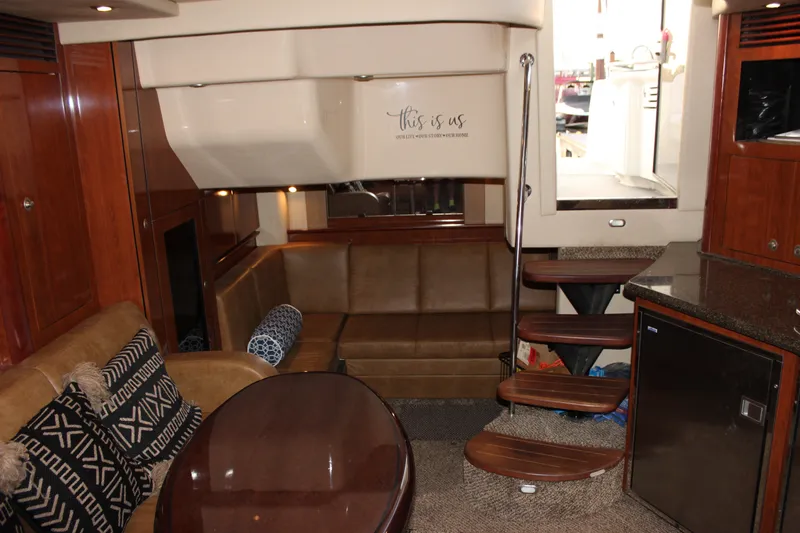 Slide: The Image of Interior of 2006 Sea Ray 40 Sundancer yacht with cozy seating and wooden finishes. - 35