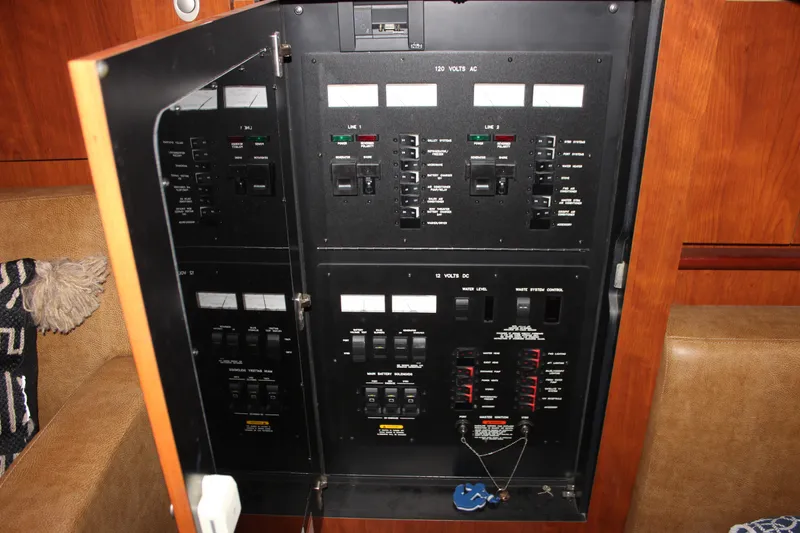 Slide: The Image of Electrical panel inside a 2006 Sea Ray 40 Sundancer yacht, featuring various switches and controls. - 50
