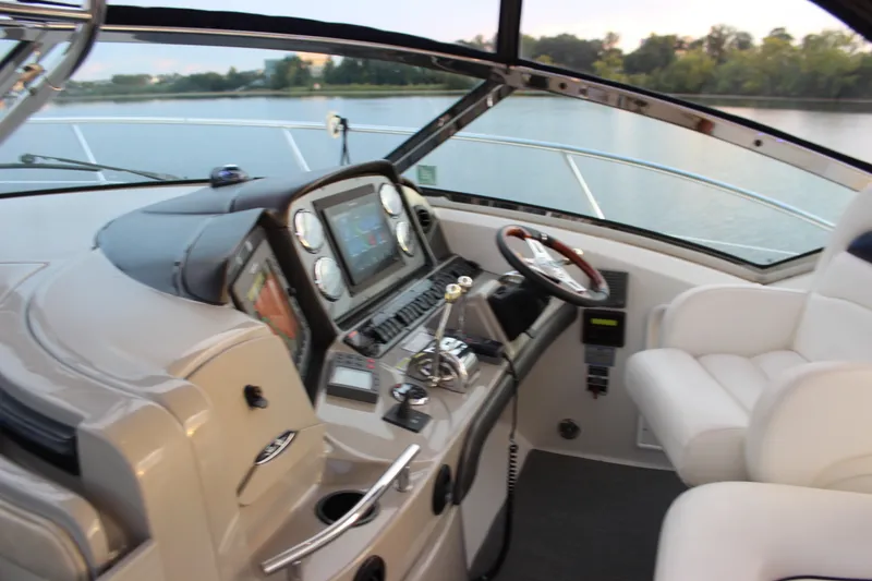 Slide: The Image of 2006 Sea Ray 40 Sundancer helm with modern controls and comfortable seating. - 17