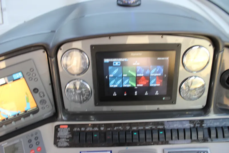 Slide: The Image of Dashboard of a 2006 Sea Ray 40 Sundancer with navigation and control displays. - 52