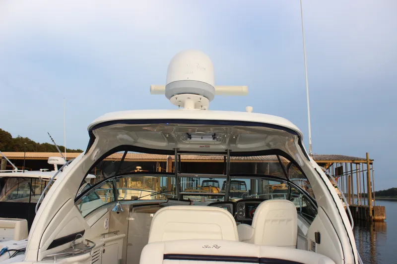 Slide: The Image of 2006 Sea Ray 40 Sundancer yacht docked, showcasing cockpit and radar equipment. - 8