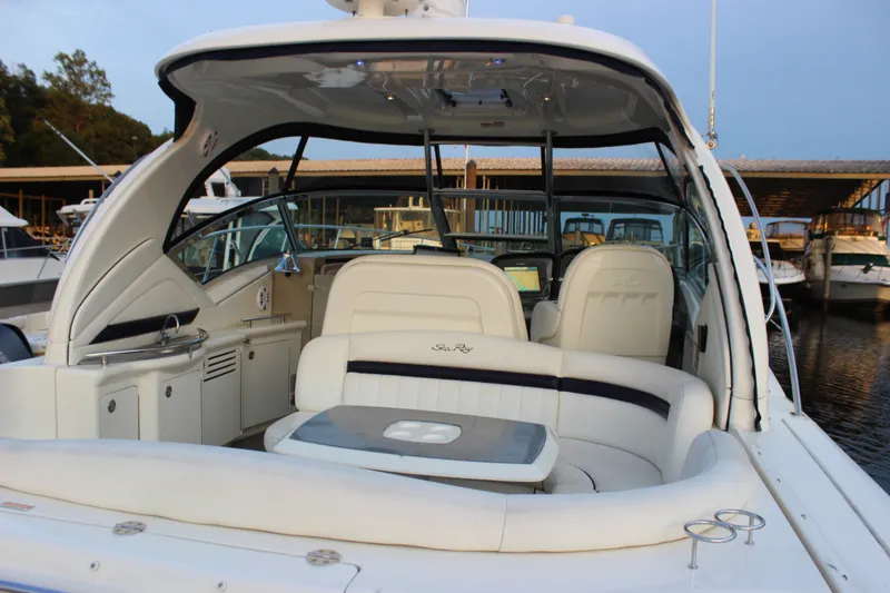 Slide: The Image of 2006 Sea Ray 40 Sundancer yacht interior with seating and helm at marina. - 7
