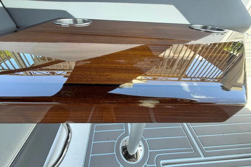 Slide: The Image of Polished wooden table with cup holders on a 2021 Cruisers Yachts 38 GLS OB. - 38