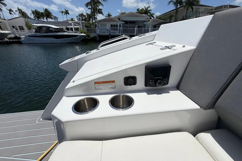 Slide: The Image of 2021 Cruisers Yachts 38 GLS OB boat interior with cup holders and control panel. - 31