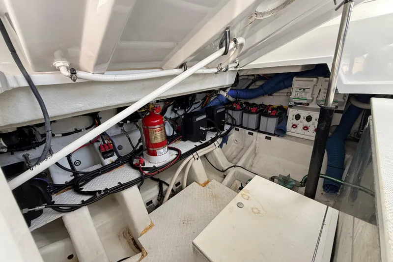 Slide: The Image of Engine compartment of 2021 Cruisers Yachts 38 GLS OB, featuring batteries and fire extinguisher. - 64