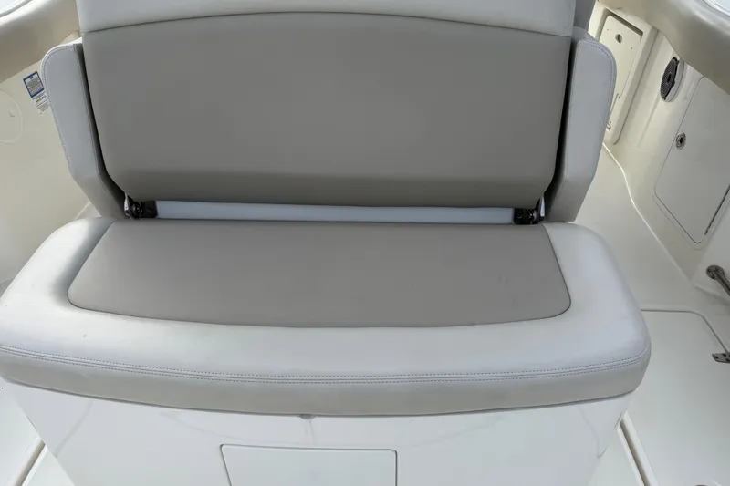 Slide: The Image of Boston Whaler 330 Outrage 2020 boat seat, featuring light gray upholstery. - 11