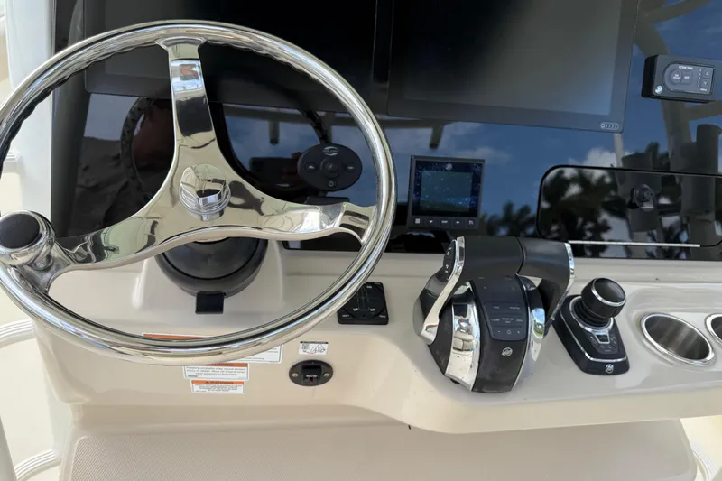Slide: The Image of 2020 Boston Whaler 330 Outrage helm with steering wheel and control panel. - 9