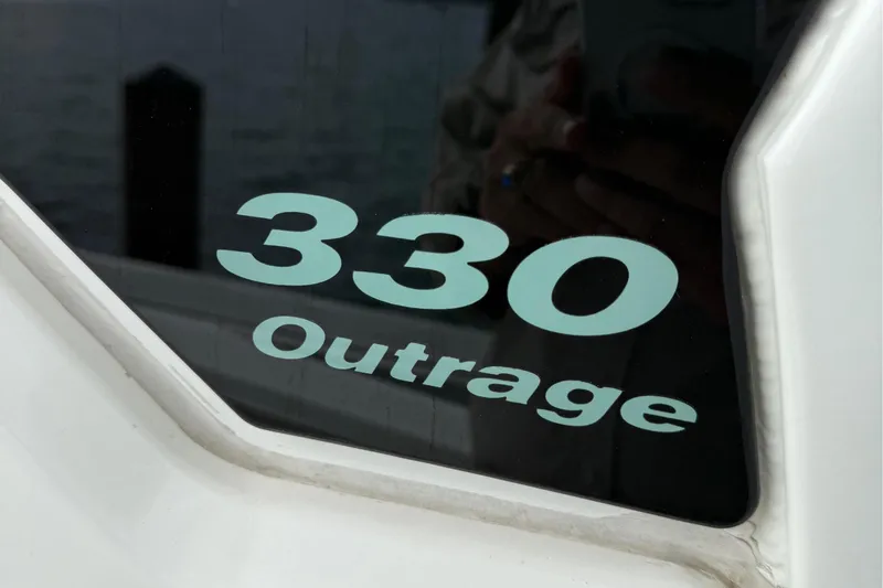 Slide: The Image of Boston Whaler 330 Outrage 2020 model name on boat window. - 24