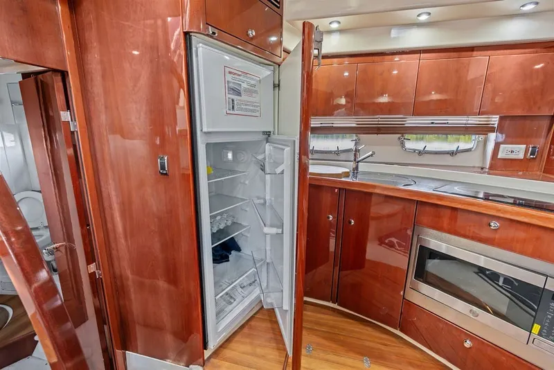 Slide: The Image of Luxurious 2006 Fairline Targa 47 GT yacht kitchen with open fridge and modern amenities. - 46