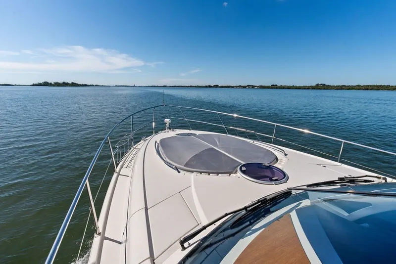 Slide: The Image of 2006 Fairline Targa 47 GT yacht cruising on calm waters under a clear blue sky. - 21