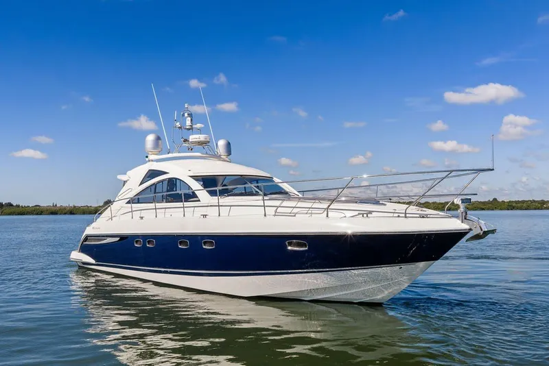 Slide: The Image of 2006 Fairline Targa 47 GT yacht on calm water under blue sky. - 5