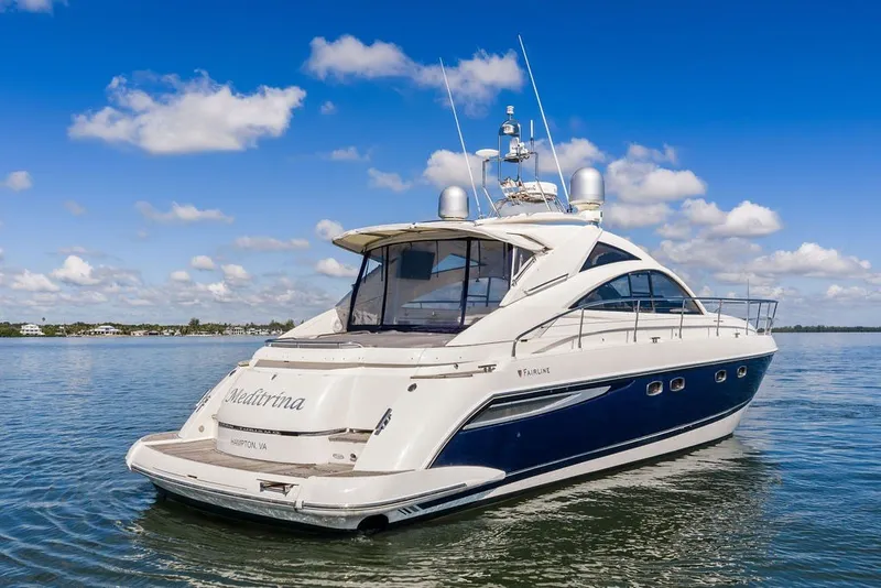 Slide: The Image of 2006 Fairline Targa 47 GT yacht on calm water under blue sky. - 7