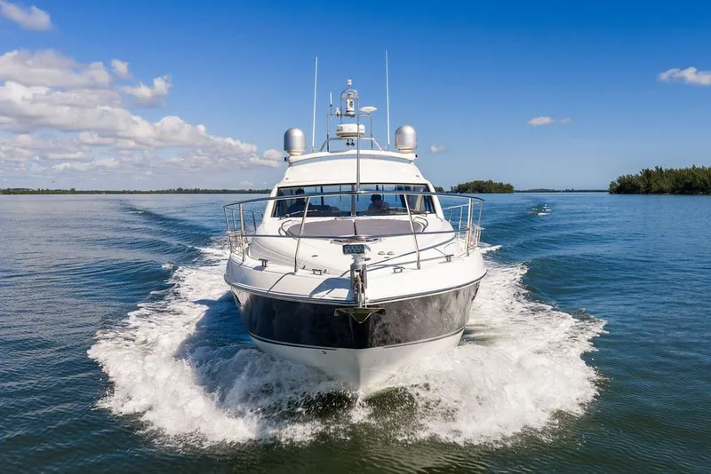 Slide: The Image of 2006 Fairline Targa 47 GT yacht cruising on open water under blue skies. - 19