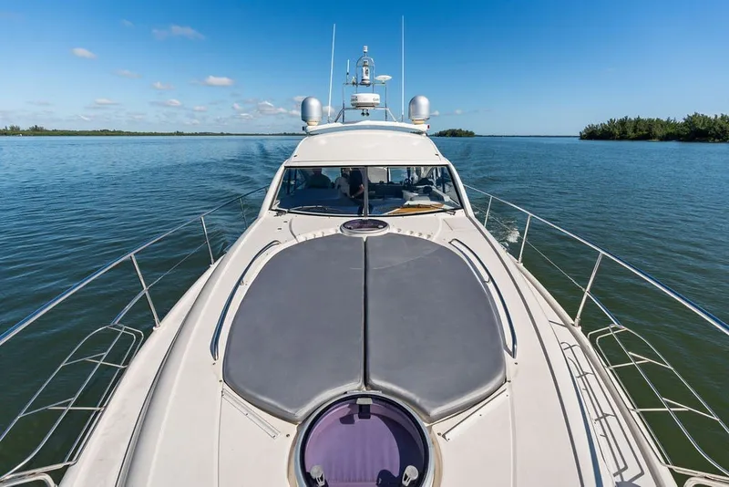 Slide: The Image of 2006 Fairline Targa 47 GT yacht cruising on calm waters under a clear blue sky. - 23