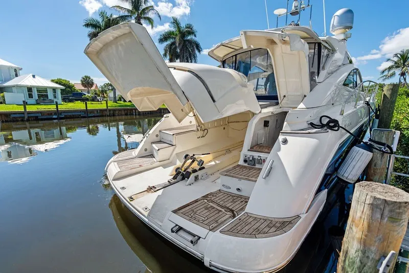 Slide: The Image of 2006 Fairline Targa 47 GT yacht docked, showcasing open rear hatch and luxurious deck. - 25
