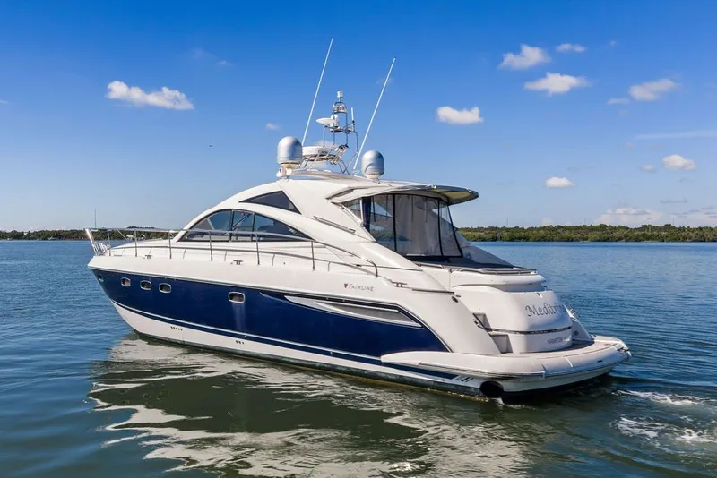 Slide: The Image of 2006 Fairline Targa 47 GT yacht cruising on calm waters under a clear blue sky. - 11