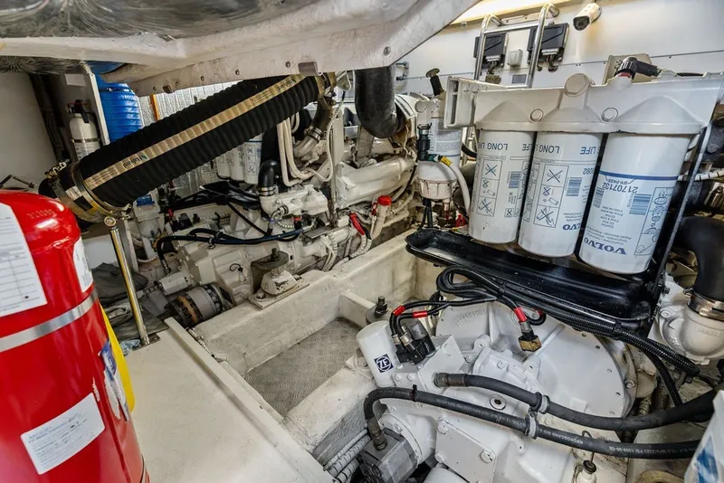 Slide: The Image of Engine room of 2006 Fairline Targa 47 GT yacht, featuring Volvo components and fire extinguisher. - 64