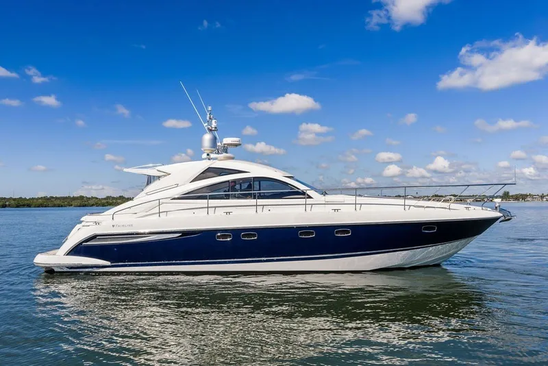 Slide: The Image of 2006 Fairline Targa 47 GT yacht on calm water under blue sky. - 6