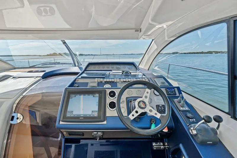 Slide: The Image of Helm of 2006 Fairline Targa 47 GT yacht with navigation controls and scenic water view. - 41
