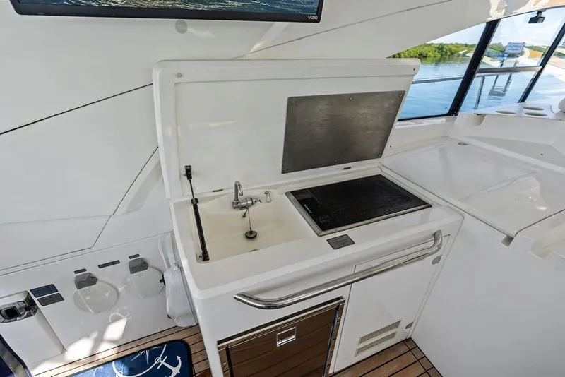 Slide: The Image of 2006 Fairline Targa 47 GT yacht kitchenette with sink and grill, overlooking water. - 35