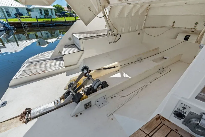 Slide: The Image of 2006 Fairline Targa 47 GT yacht interior with open storage compartment and dock view. - 28