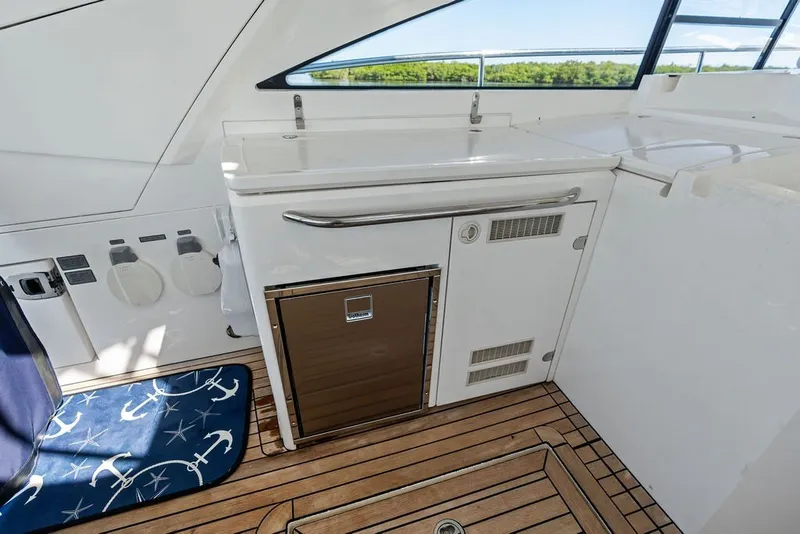 Slide: The Image of Interior of 2006 Fairline Targa 47 GT yacht with wooden flooring and compact kitchenette. - 34