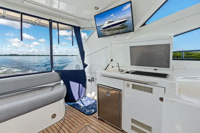 Slide: The Image of Interior of 2006 Fairline Targa 47 GT yacht with kitchenette and scenic water view. - 36