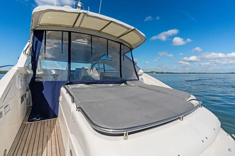 Slide: The Image of 2006 Fairline Targa 47 GT yacht on calm water under clear blue sky. - 30