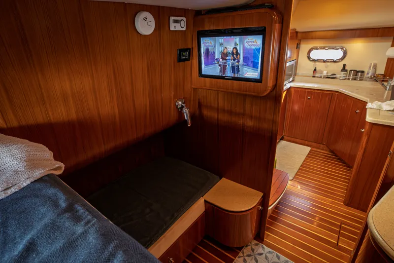Slide: The Image of Interior of a 2006 Tiara Yachts 4400 Sovran with wood finish and a television. - 28