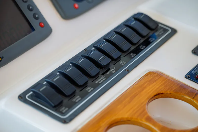 Slide: The Image of Close-up of a control panel area with toggle switches and wood accents. - 19